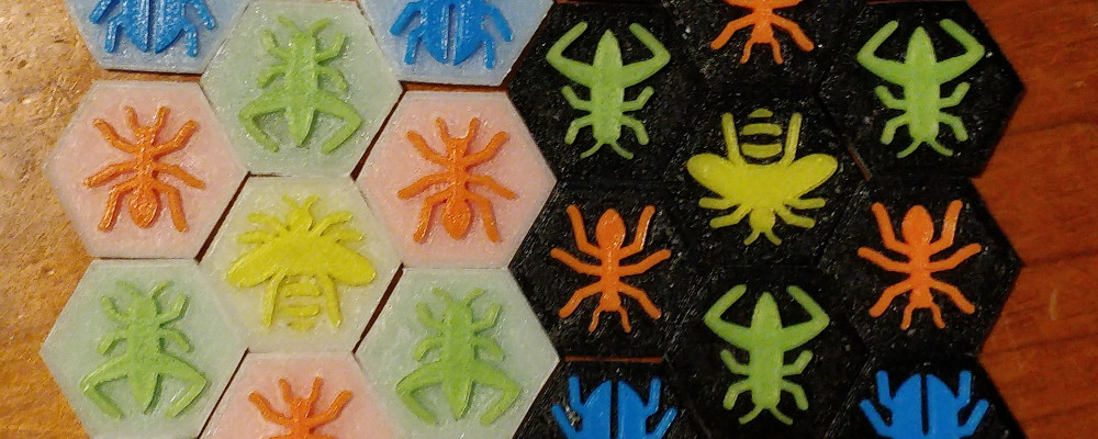 A set of printed game pieces, with coloured pieces for both players